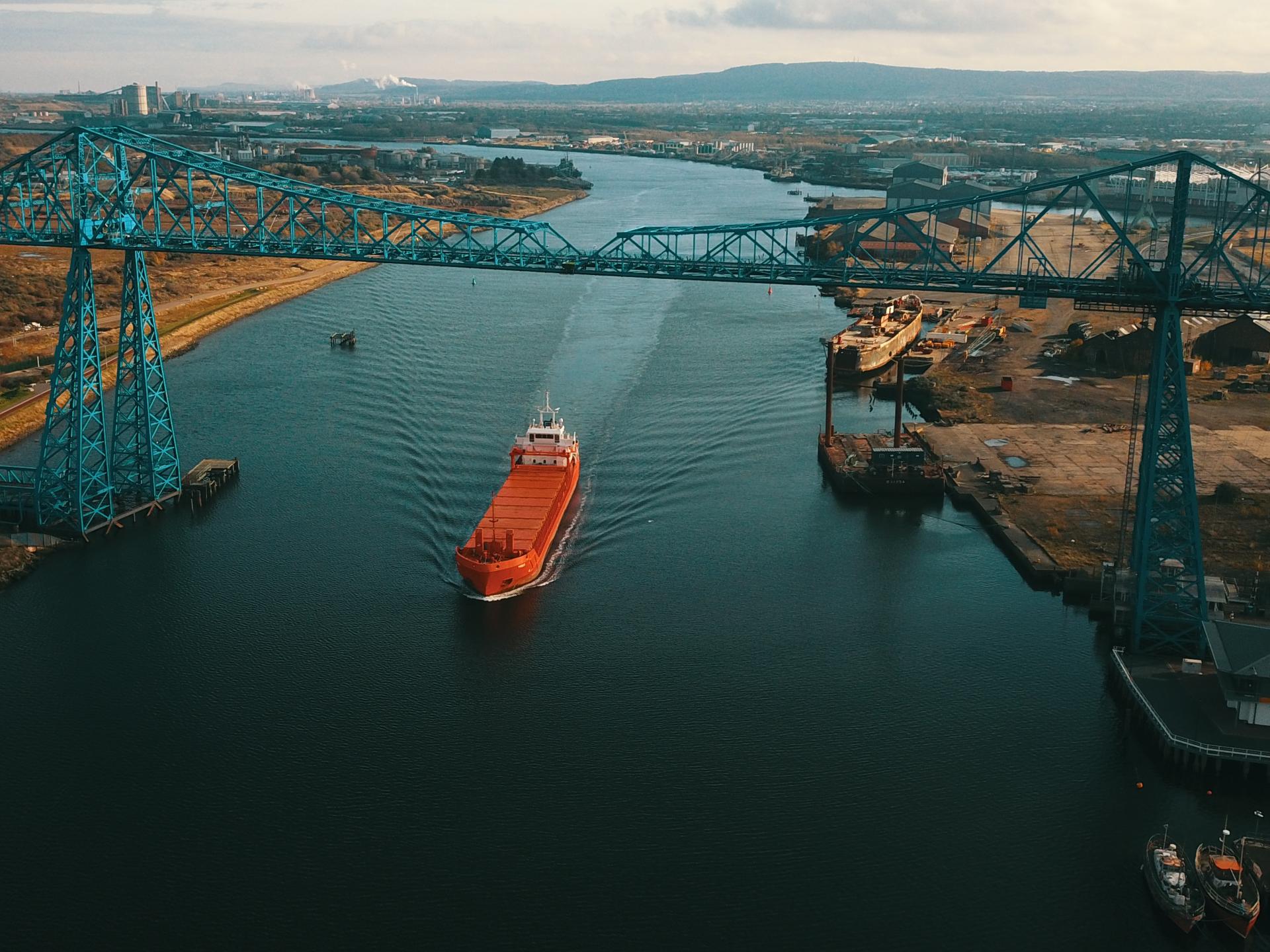 Aerial view of a ship passing under the Tees Transporter Bridge on the River Tees
